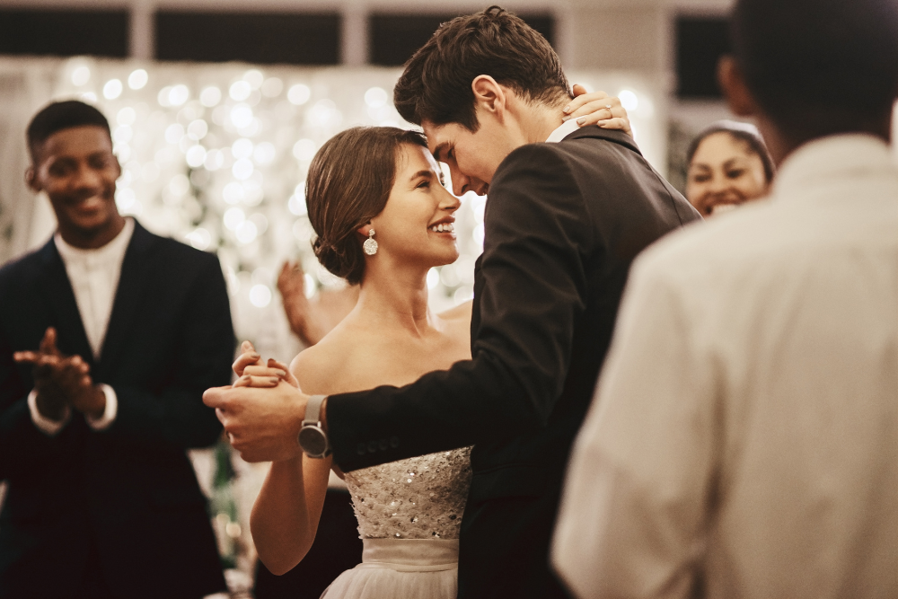 Newlyweds sharing their first dance in an indoor ballroom — inspiration for how to choose a wedding venue with emotion.