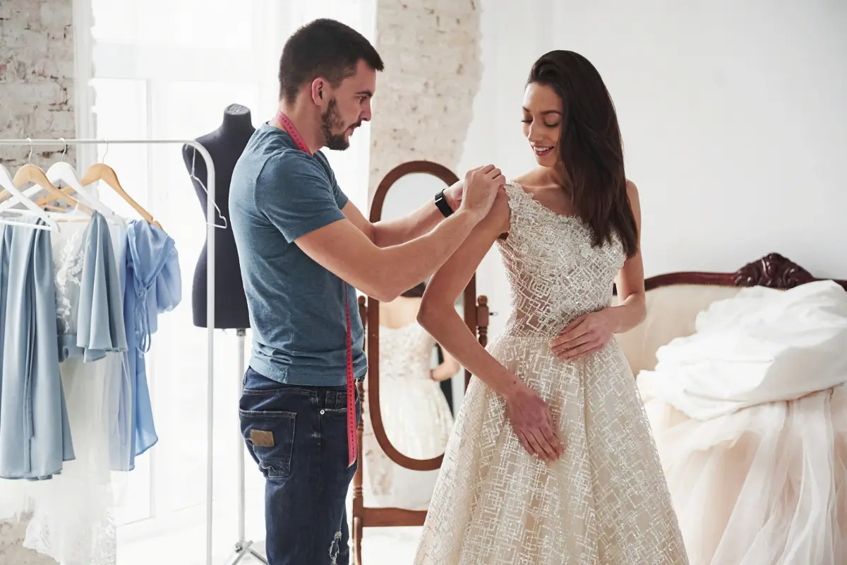 Bride Attending A Dress Fitting Appointment During The Later Stages Of Wedding Preparation And Coordination
