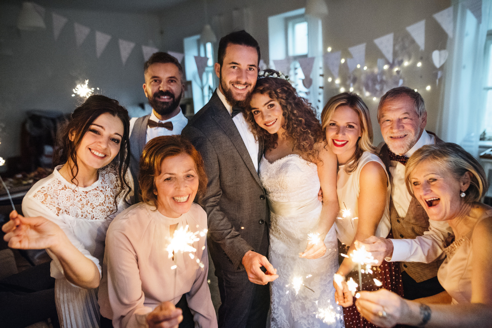 Newlyweds posing with guests, highlighting 2025 wedding trends focused on personal moments.